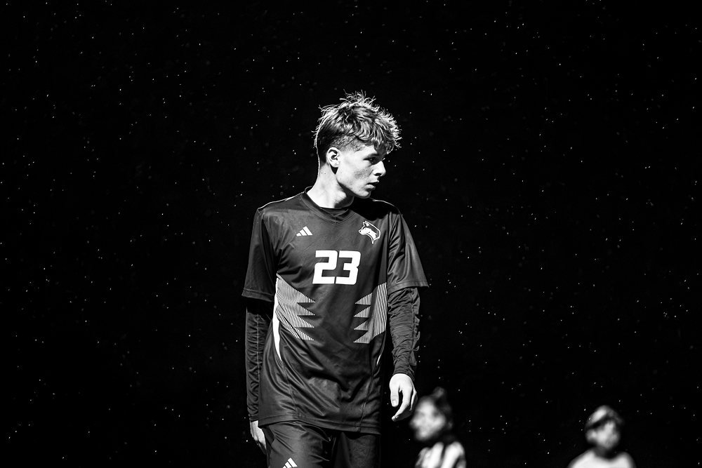 Black and white of soccer player number twenty-three at night